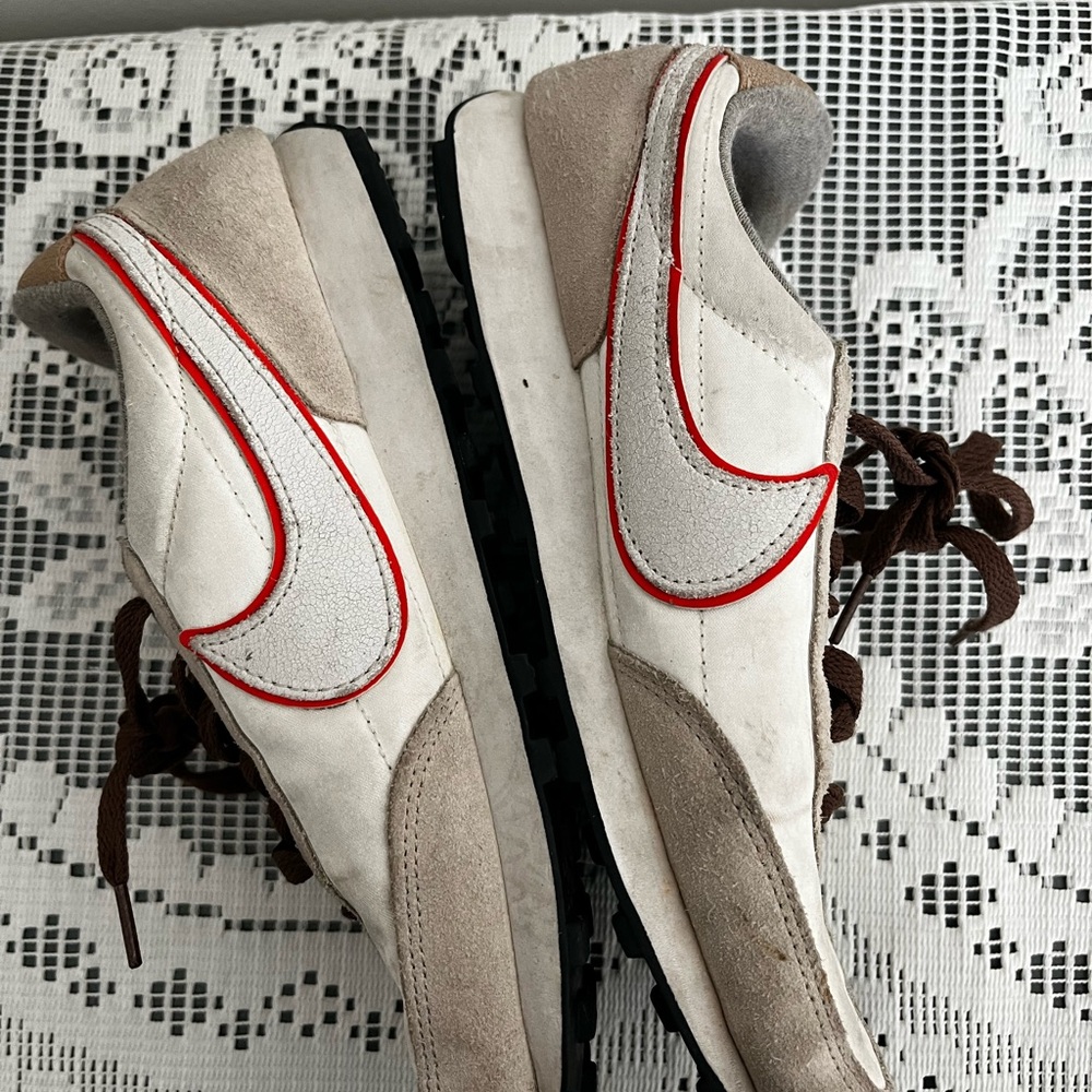 Woman’s Nike White and Brown Sneakers with Orange Accent